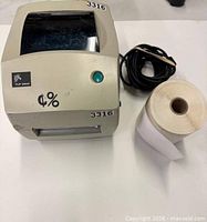 Top view of Zebra TLP 2844 printer with cable and label roll