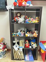 Full view of 8-cube shelf loaded with toys (not included) and folded bins at bottom