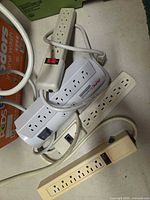 Group view of all four power strips showing outlets, cords and switches