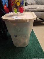 Large clear bin with beige lid, paw-print jar on top