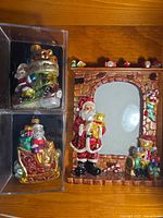 Overall view of two boxed ornaments and Santa picture frame
