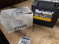 Duralast Gold battery alongside YTZ10S Motocross box