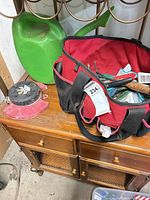Bag, watering can, rotary sprinkler visible
