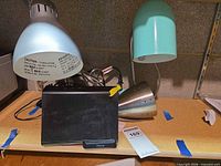 iHome dock centered between silver and turquoise lamps on shelf