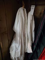 Ivory pleated drapery panel hanging, shows overall length and color