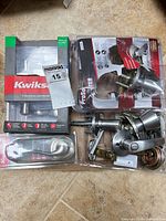 Multiple packaged and loose satin nickel lever locksets with hardware