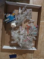 Overview of tangled clear-wire clip lights with snowman plug and battery boxes