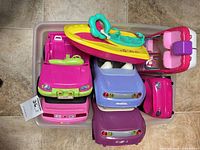 Tub containing multiple toy cars and boats