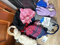 Overall view of pile showing hats, gloves, scarves and earmuffs