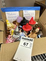 Box containing eight mini Wizard of Oz dolls