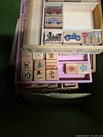 Stacked wooden trays showing vehicle stamps and holiday icon stamps