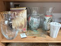 Group shot showing gold-rim vase with box, two flared vases, rectangular vase, ceramic flower frog