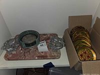 Overall lot: marble base with bookends, stone ashtray with silver coasters, box of gold/green coasters