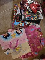 Stack of assorted themed gift bags showing Disney Princess, Marvel Spider-Man, DC Superman and others