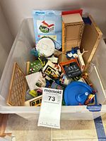 Top view of bin showing mixed Playmobil pieces, figures, building parts and accessories