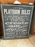 Front view of gray and white "Playroom Rules" wall plaque showing full text and condition
