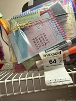 Contents of clear pouch showing notepads, markers, eraser, straps
