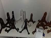 Group of wood and acrylic folding easels in various colors on shelf