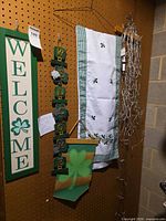 Full lot showing wood welcome sign, shamrock garland, fabric runner, burlap banner, bundled lights