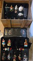 Wood crate with two storage trays holding multicolour glass Christmas ornaments