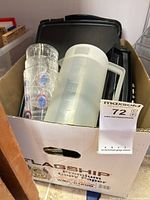 Box containing plastic measuring pitcher, four patterned glasses, black electric griddle