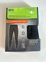 Front of sealed retail package showing Athletic Works branding, size L/G, midweight base layer pant details