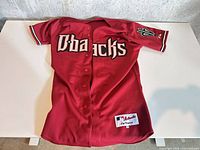 Front view of red Diamondbacks jersey showing logo and full design