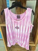 Full front view of pink tie-dye Harley-Davidson tank top on hanger
