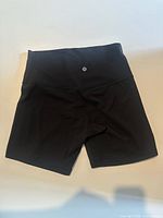 Front view of black Lululemon shorts showing logo and style