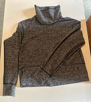 Front view of dark heather grey funnel-neck Lululemon sweater displayed flat