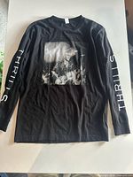 Full view of black Sam Smith long sleeve T-shirt showing chest graphic and sleeve text