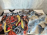 Four shirts laid flat showing front graphics