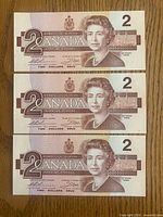 Front view of three sequential 1986 $2 notes