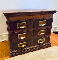 Front view showing six drawers with brass pulls