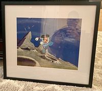 Full view of framed animation cel showing frame, mat, and artwork