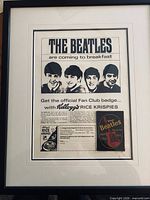 Full view of framed advertisement displaying Beatles imagery, coupon, and badge