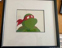 Front view of framed Raphael production cel