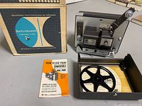 Projector accessories with cardboard box, take-up reel and manual