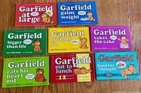 Eight early-series horizontal Garfield paperbacks laid out showing front covers