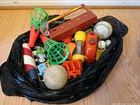 Bag containing assorted vintage toys and balls