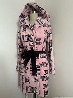 Front view of pink plush hooded robe on dress form
