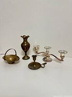 Group shot of all brass pieces and silver candelabra