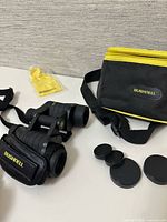 Full set showing binoculars, case, lens caps, cloth