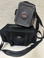 Front view showing both Optex nylon bag and Flamin' hard case