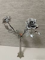 Full view of chrome roses arrangement in glass vase