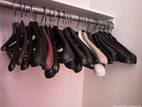 Front view of assorted plastic hangers on rod