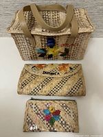 Front view of handbag, clutch and wallet showing design and size