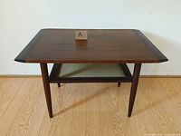 front angled view showing tabletop, legs and shelf