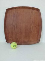 Full view of square teak tray with tennis ball for scale