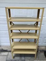 Front view of beige metal shelving unit with five shelves